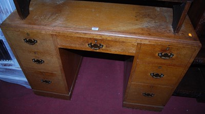 Lot 1421 - A 1930s limed oak kneehole writing desk,...