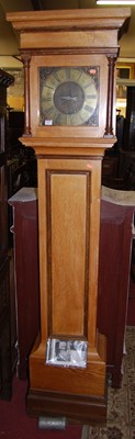 Lot 1423 - A light oak longcase clock by James Mogg of...