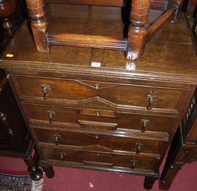 Lot 1426 - A 1920s geometric moulded oak chest of four...