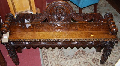 Lot 1427 - A late 19th century heavily carved oak...
