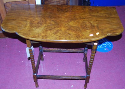 Lot 1430 - An early 20th century walnut shaped top bobbin...