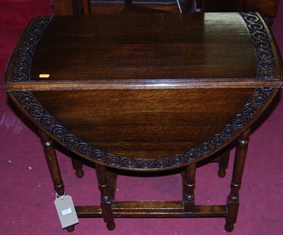 Lot 1437 - An early 20th century floral relief carved oak...