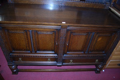Lot 1458 - An early 20th century moulded oak ledgeback...