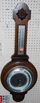 Lot 1459 - A 1930s oak aneroid two dial wheel barometer