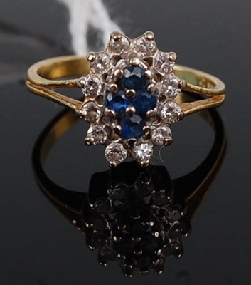 Lot 340 - An 18ct gold, sapphire and diamond flower-head...