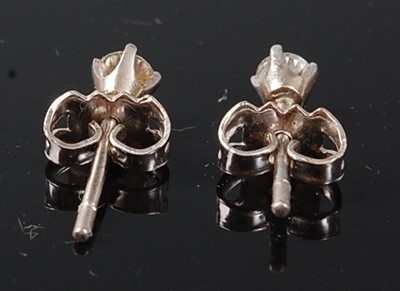 Lot 2511 - A pair of white metal diamond stud earrings,...