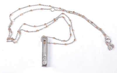 Lot 2515 - A 9ct white gold diamond bar pendant,...
