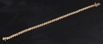 Lot 2513 - A yellow metal diamond line bracelet,...