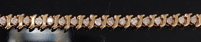 Lot 3110 - A yellow metal diamond line bracelet,...