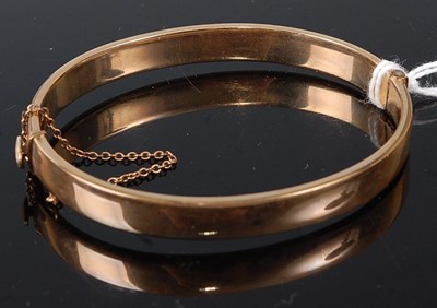 Lot 313 - A gilt metal half engraved oval hinged bangle,...