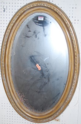 Lot 1081 - A gilt framed oval bevelled wall mirror, with...