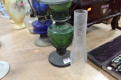 Lot 102 - An early 20th century oil lamp having a blue...
