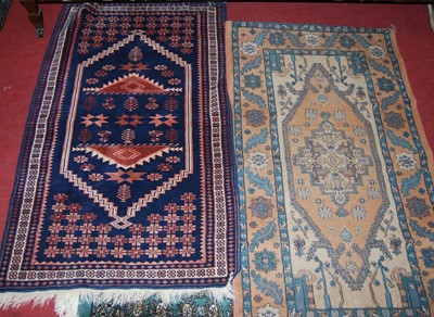 Lot 1102 - A small Turkish woollen blue ground hall rug,...