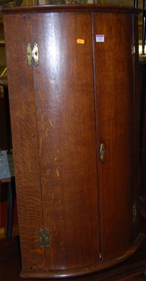 Lot 1131 - A 19th century oak bowfront double door...