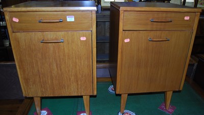 Lot 1153 - A pair of 1950s light oak single door bedside...