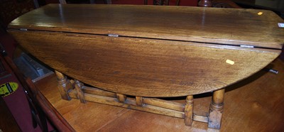 Lot 1163 - A contemporary joined oak low dropflap coffee ...