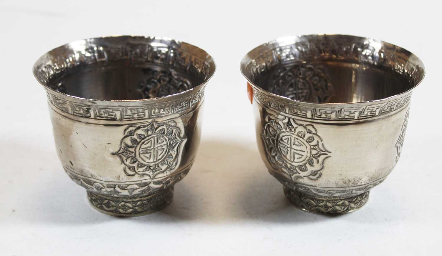 Lot 244 - A pair of Eastern white metal cups, each...