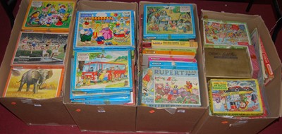 Lot 1268 - Four boxes of various jigsaws including Rupert...