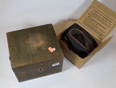 Lot 424 - A Home Guard gas mask, dated 1937, in card...