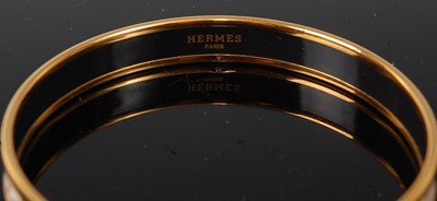 Lot 160 - A Hermès gold plated and printed white enamel...