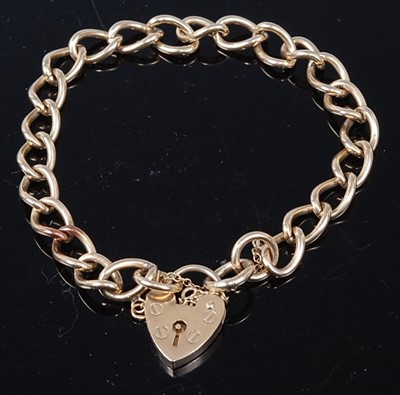 Lot 328 - A 9ct gold curb link bracelet with heart...