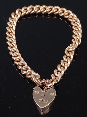 Lot 332 - A 9ct gold curb link bracelet having heart...