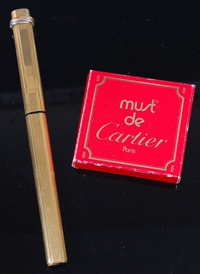 Lot 335 - A Cartier fountain pen, in reeded gold plated...