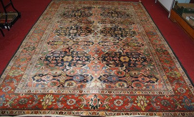 Lot 1196 - A Persian woollen rug, the central ground...