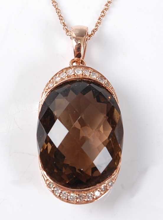 Lot 2525 - A rose metal, smoky quartz and diamond pendant,...
