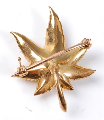 Lot 2524 - A 9ct yellow gold Maple leaf brooch, having a...