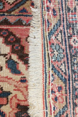 Lot 1358 - A Persian woollen Heriz carpet, the red ground...