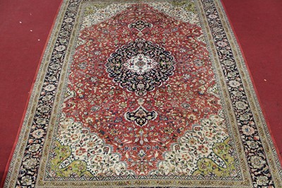 Lot 1360 - A Persian woollen Heriz carpet, the red ground...