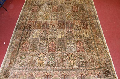 Lot 1361 - A Persian woven silk carpet, the central...