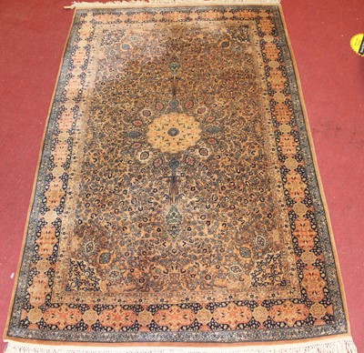 Lot 1363 - A Persian woollen Qum rug, the shaded brown...