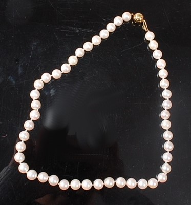 Lot 2543 - A single row necklace of forty-seven approx...