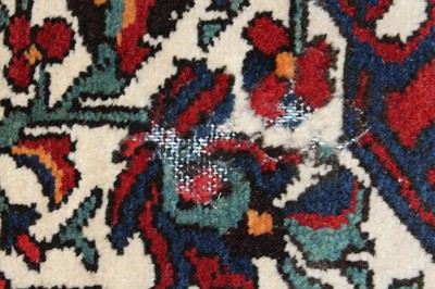 Lot 4 - * A Persian woollen Herat rug, the red ground...