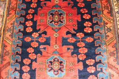 Lot 8 - * A Persian woollen Kazak rug, the blue ground...