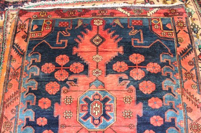 Lot 8 - * A Persian woollen Kazak rug, the blue ground...