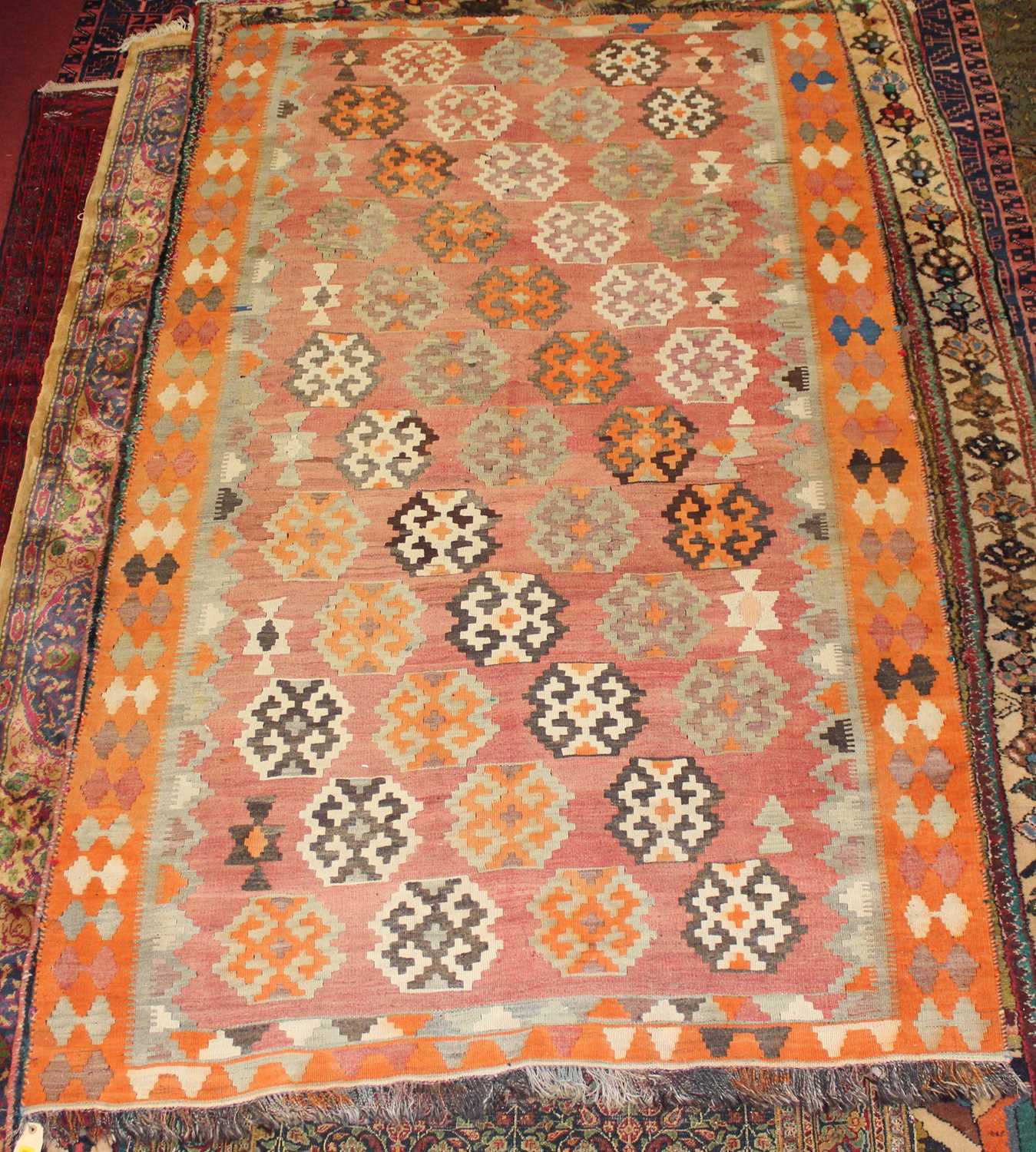 Lot 9 - * A Turkish woollen Kilim rug, the faded red...