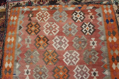 Lot 9 - * A Turkish woollen Kilim rug, the faded red...