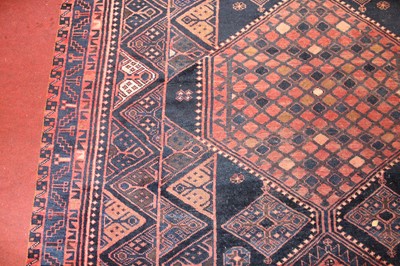 Lot 12 - * A Turkish woollen rug, the blue ground...