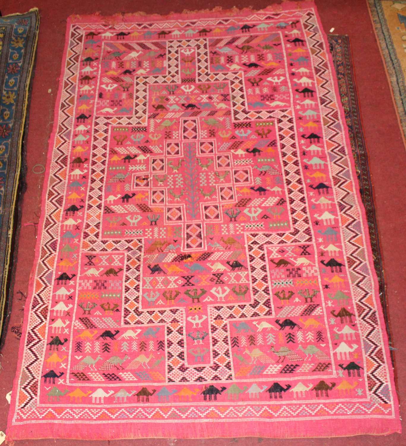 Lot 21 - * A Turkish woollen Kilim rug, the pink ground...