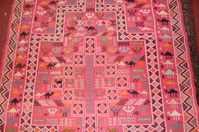 Lot 21 - * A Turkish woollen Kilim rug, the pink ground...
