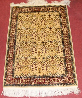 Lot 1364 - A Turkish silk Hereke rug, the cream ground...
