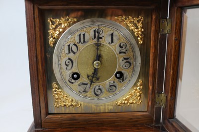 Lot 11 - A late 19th century oak cased mantel clock,...
