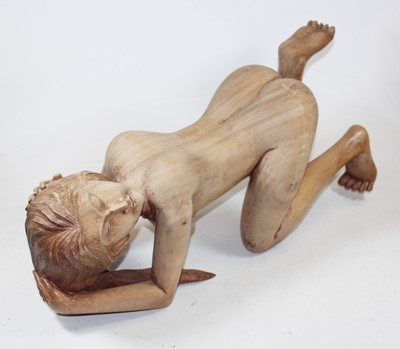 Lot 27 - An Eastern carved hardwood figure of a nude...