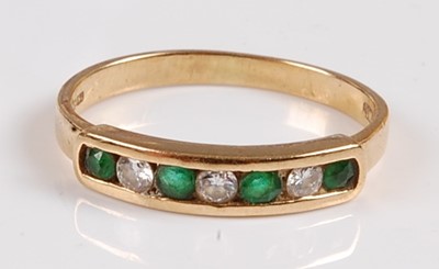 Lot 2552 - An 18ct yellow gold, emerald and diamond seven...