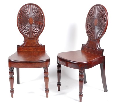 Lot 1473 - A pair of late Georgian mahogany hall chairs,...