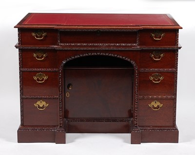 Lot 1465 - A reproduction mahogany kneehole desk, in the...