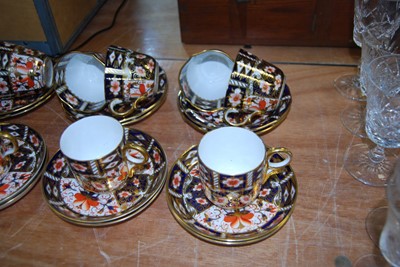 Lot 110 - A set of eleven Royal Crown Derby coffee cans...